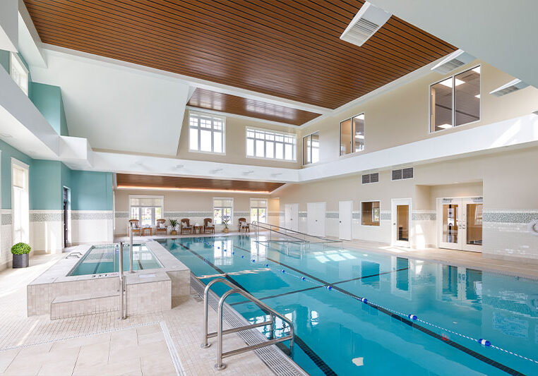 Indoor swimming pool area with lounge chairs