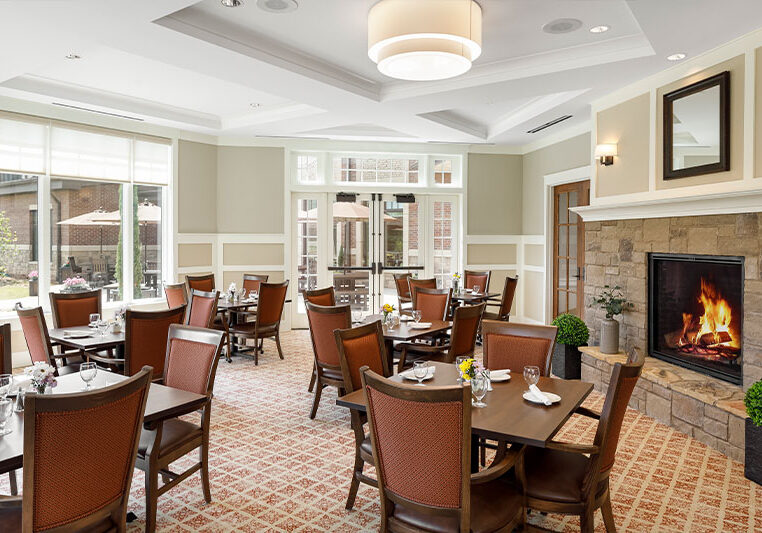 Dining area with tables and a cozy fireplace