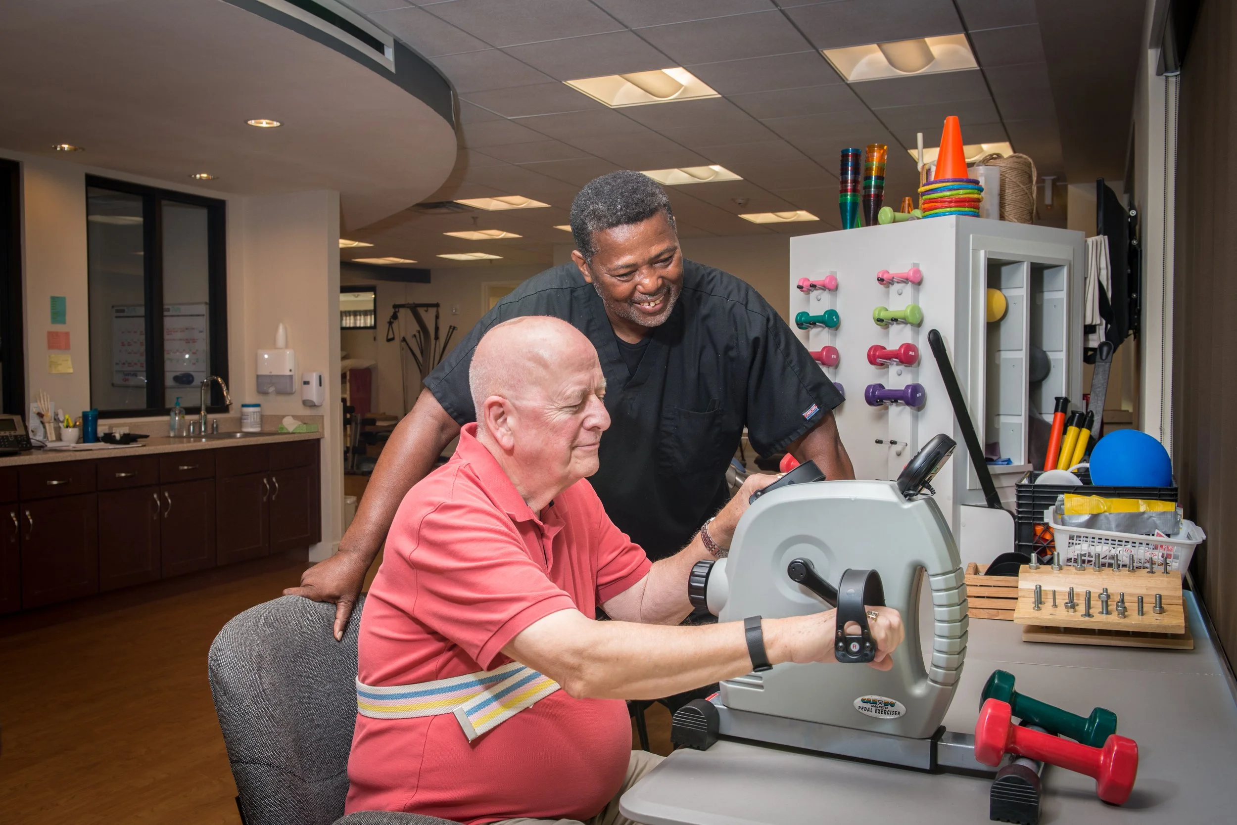Staff assisting a resident with therapy exercises