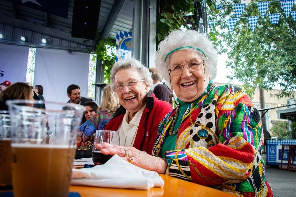 Two smiling residents enjoying an outdoor activity event