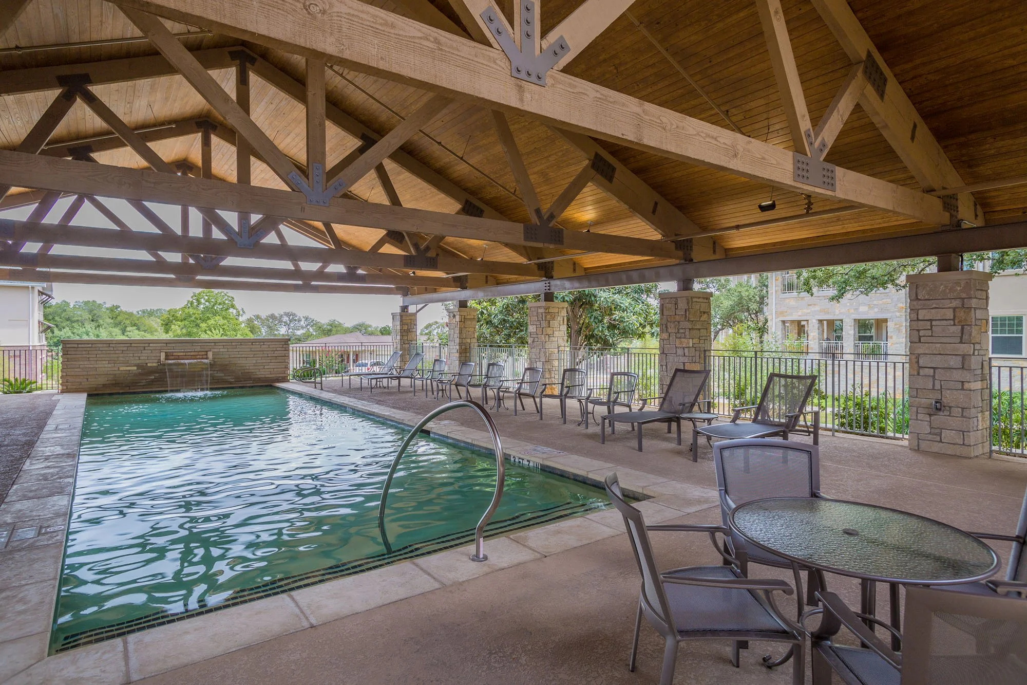 Indoor pool area with seating and covered patio
