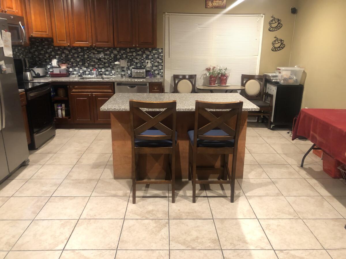 Interior kitchen area with granite countertops and bar stools