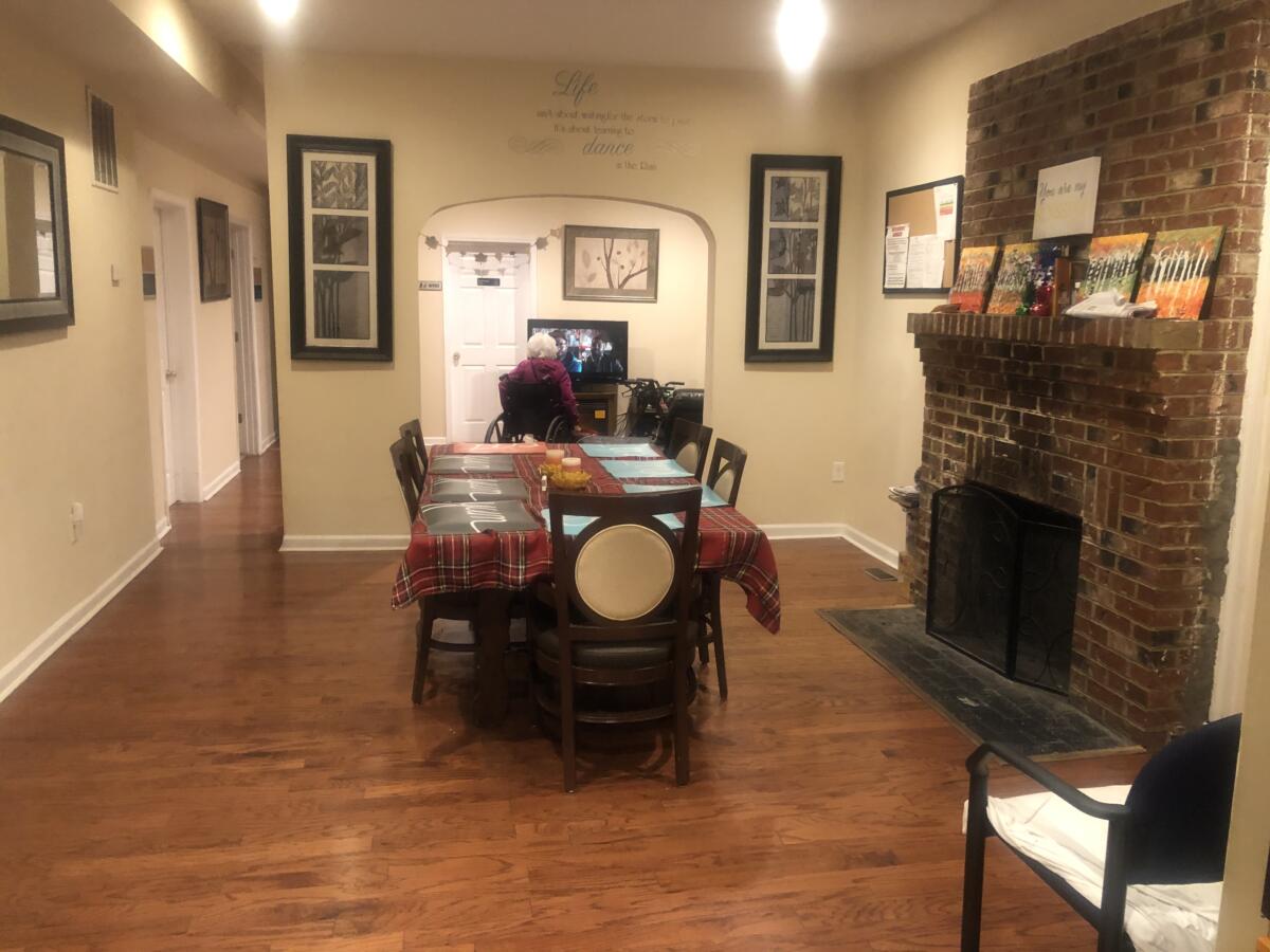 Cozy common area with a dining table and brick fireplace