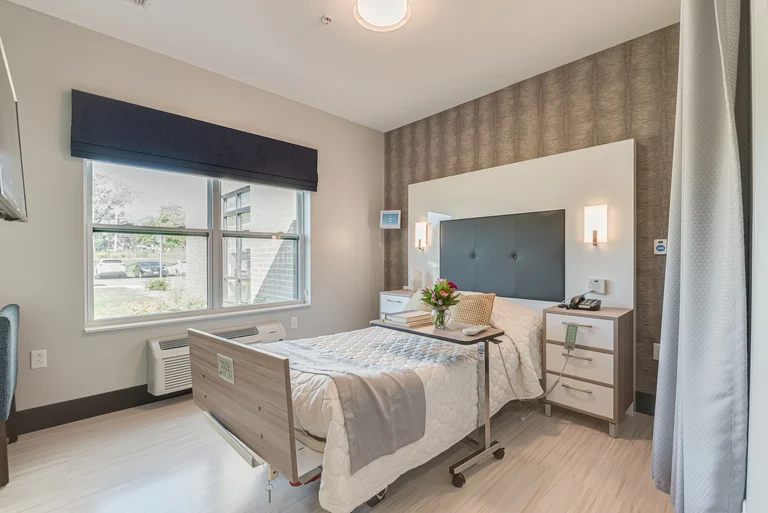 Well-decorated resident room with bed and window