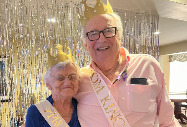 Two residents celebrating with crowns at a party.