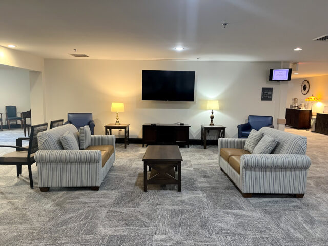 Cozy common area with seating and a TV.