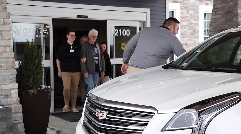 Residents and staff at the facility's entrance