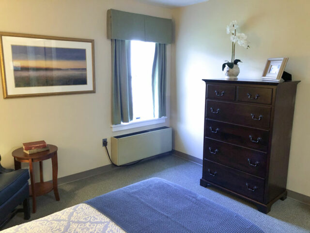 Well-furnished resident room with natural light