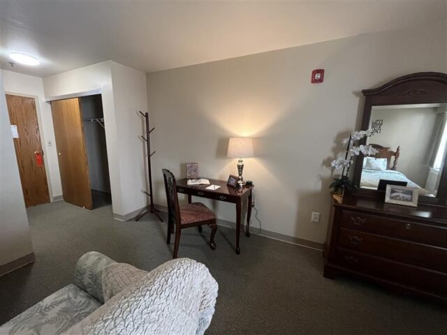 Cozy resident room with desk and furniture