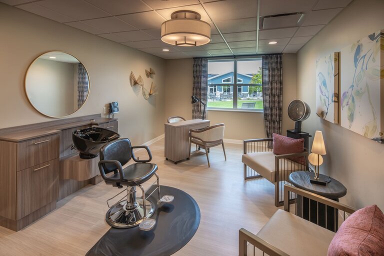 Stylish salon area with chairs and mirrors.