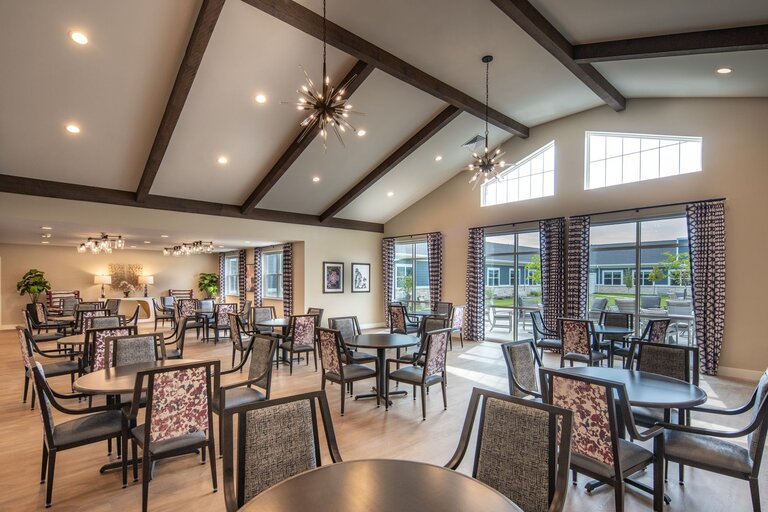 Dining area with tables and chairs in a well-lit room