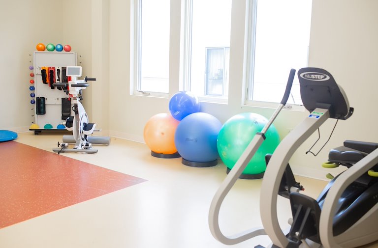 Fitness area with exercise equipment and stability balls.
