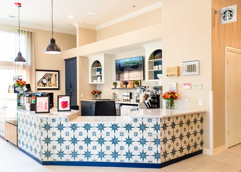 Reception area with floral arrangements and coffee station.