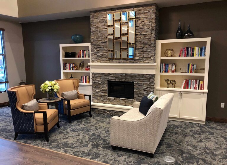 Cozy common area with seating and bookshelves.