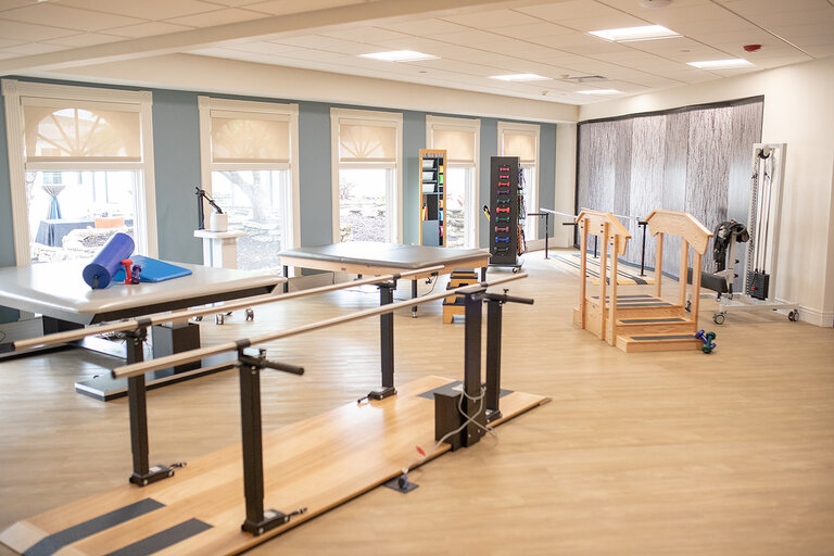 Physical therapy room with rehabilitation equipment.