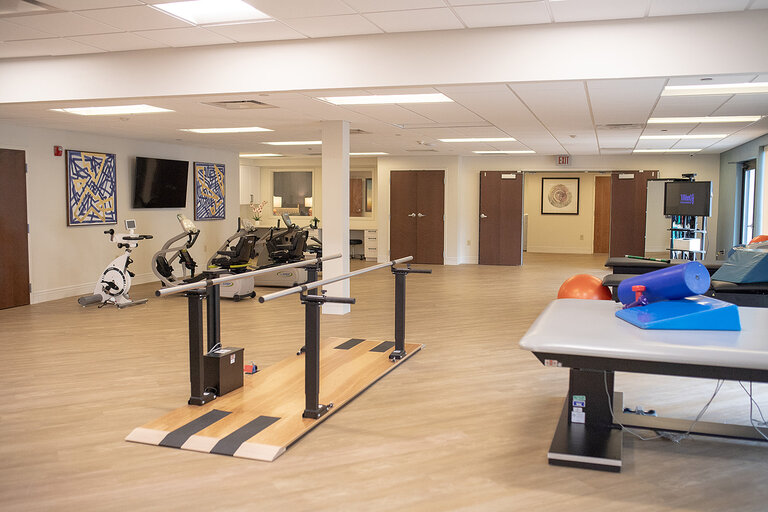 Therapy room with equipment and workout stations.
