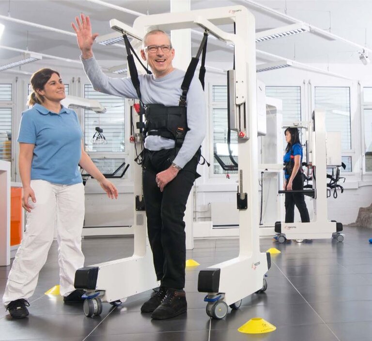 Resident interacting with staff in a rehabilitation setting.