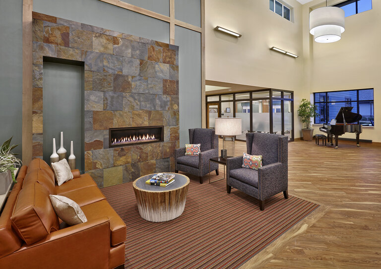 Modern lobby area with seating and a piano