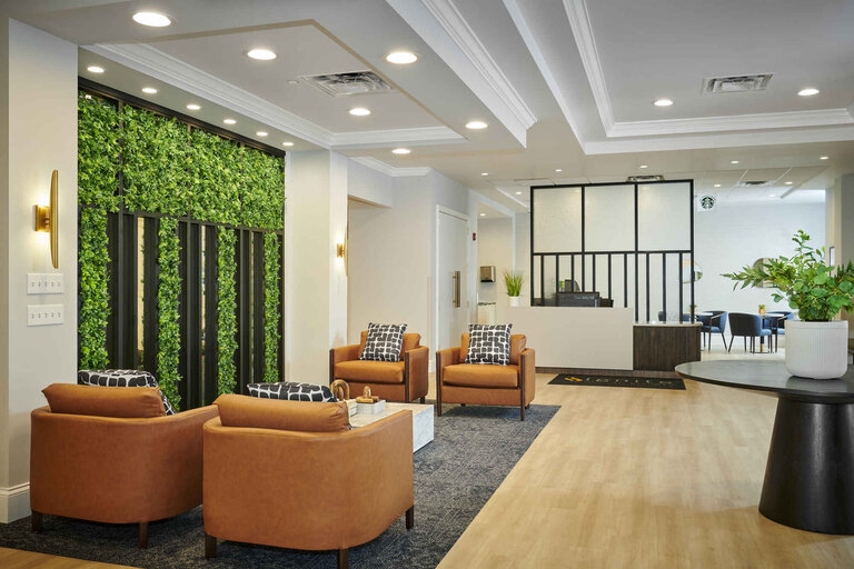 Modern lobby area with seating and greenery