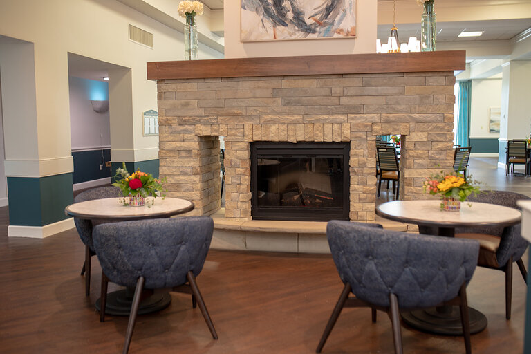 Cozy common area with a fireplace and seating.