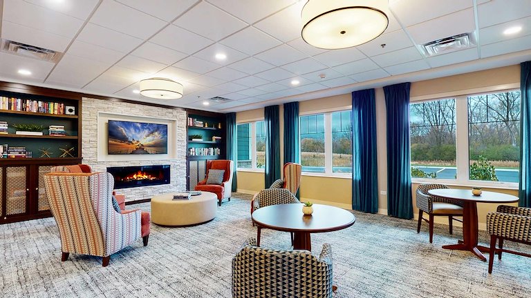 Cozy common area with seating and large windows.