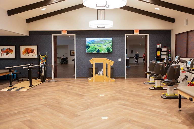 Therapy room with equipment and artwork.