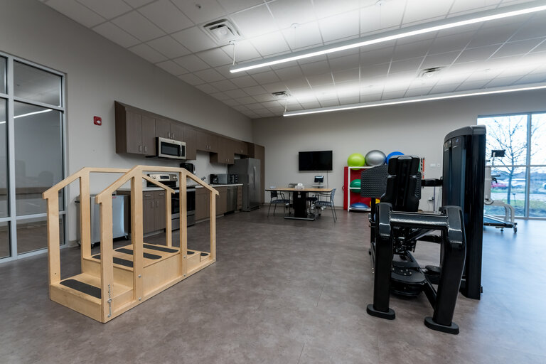 Interior rehabilitation space with equipment and open layout.