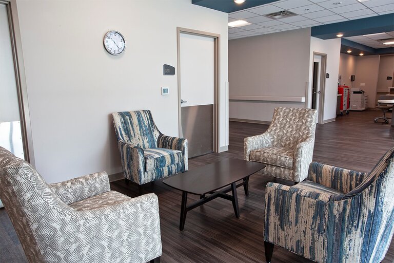Seating area with chairs and a clock