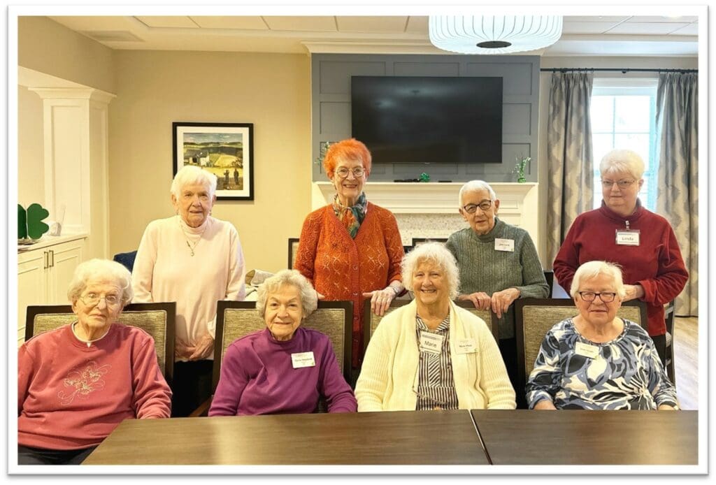 Group of residents smiling in a common area.