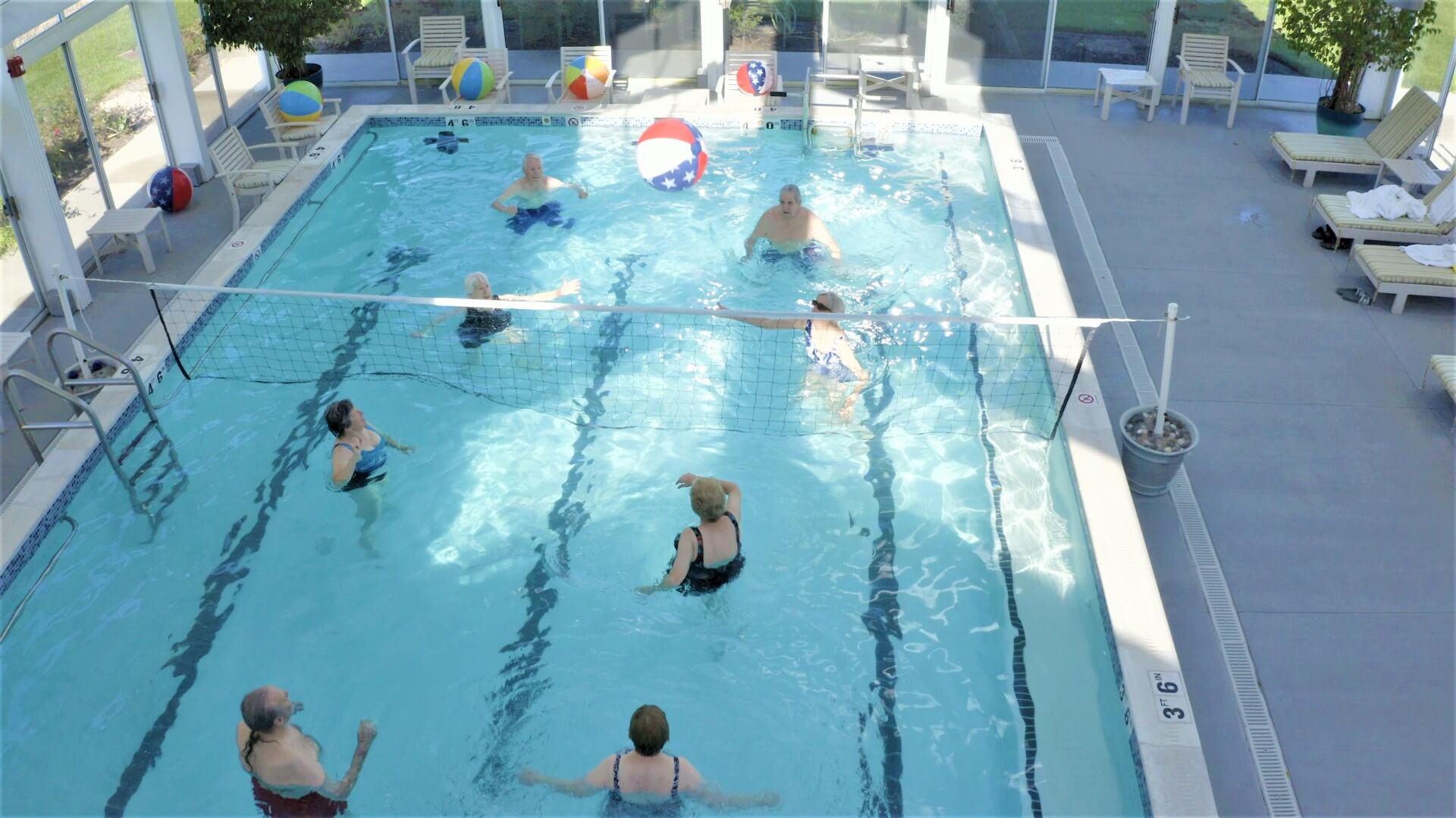 Residents engaging in water volleyball activity