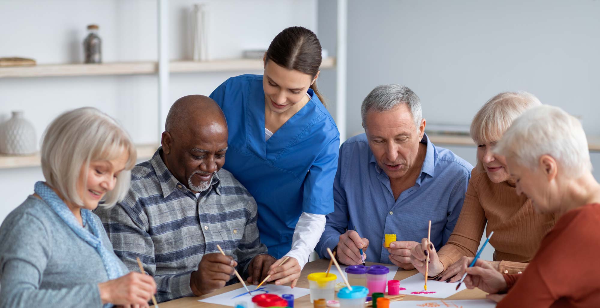 Residents and staff engaged in an art activity