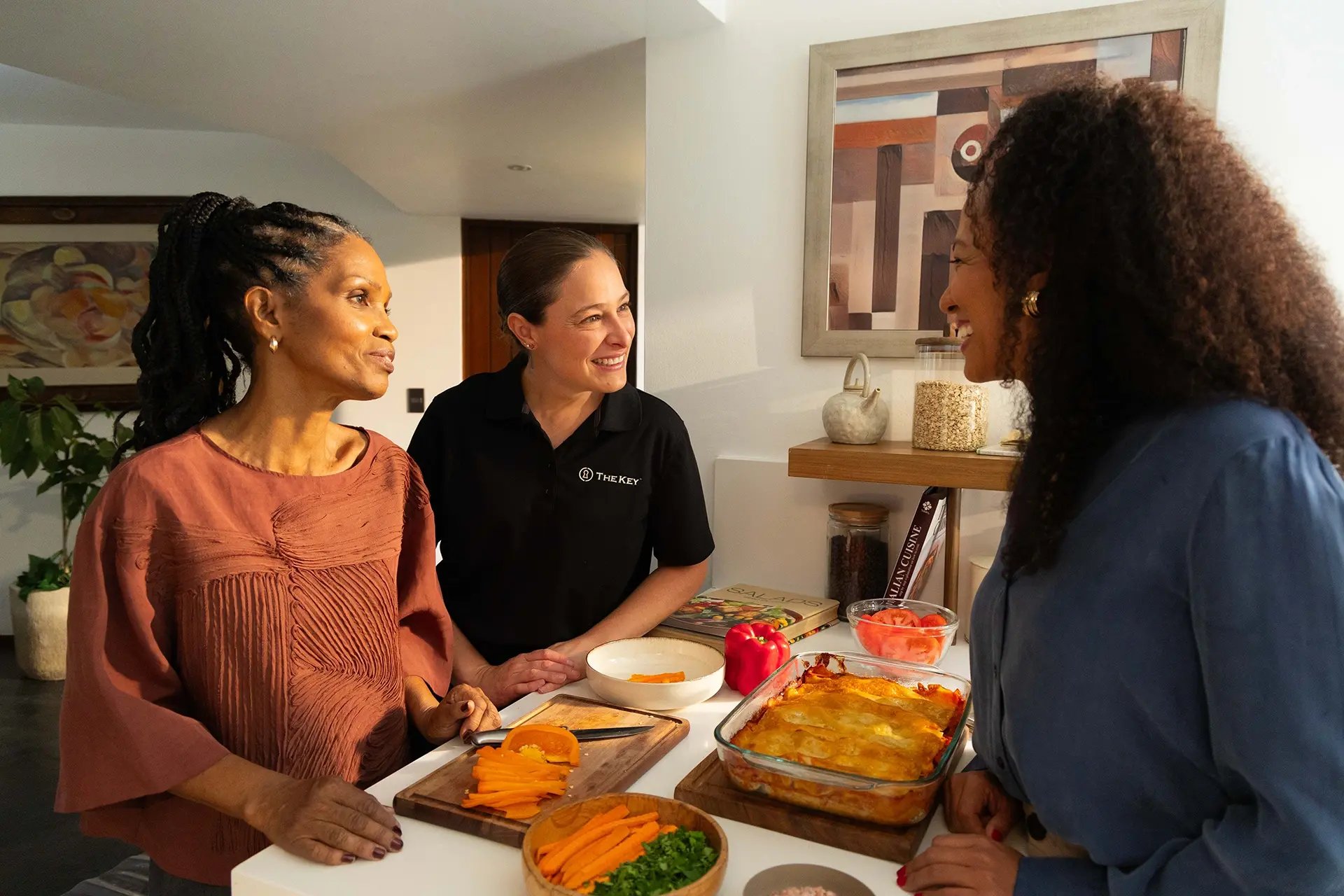Residents and staff interacting over a meal preparation