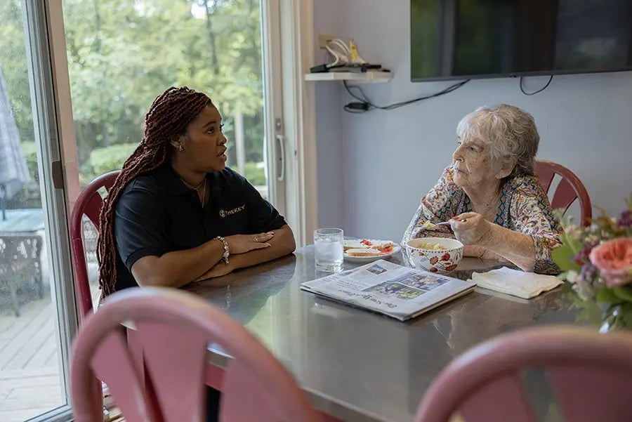 Staff member engaging with resident at a table