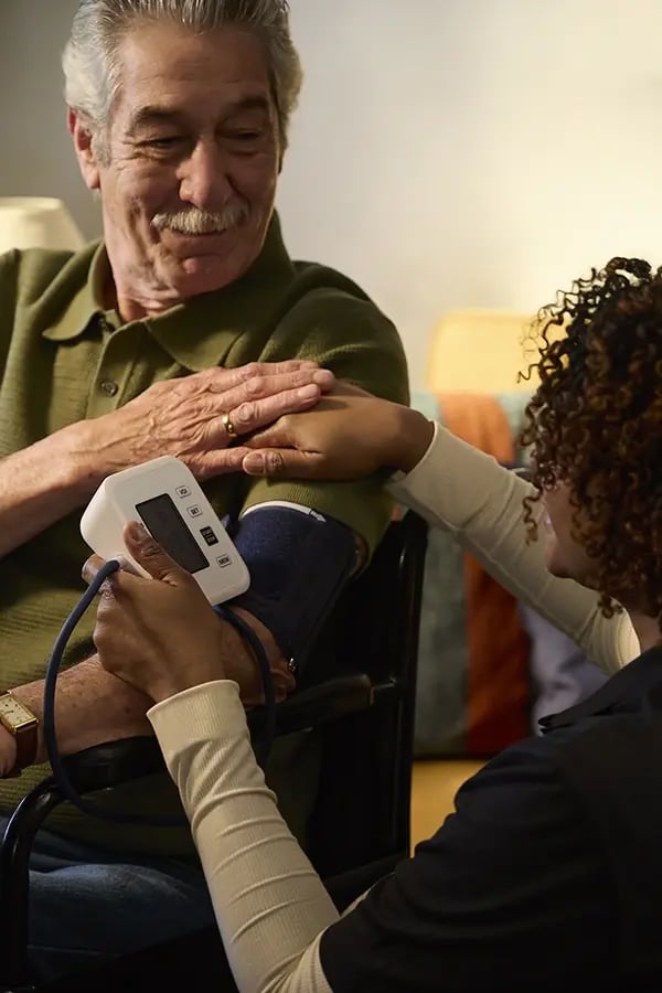 Healthcare professional checking a senior's blood pressure