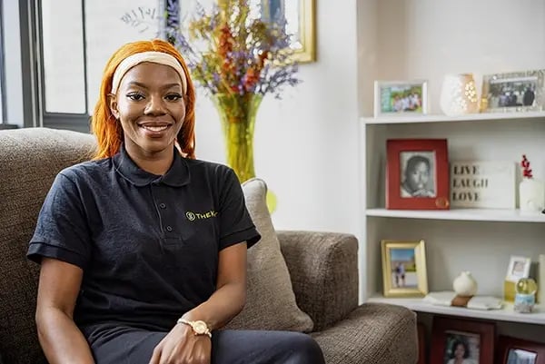 Smiling staff member in a cozy common area