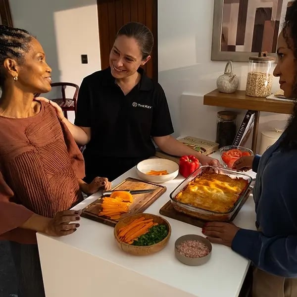 Residents and staff engaged in meal preparation