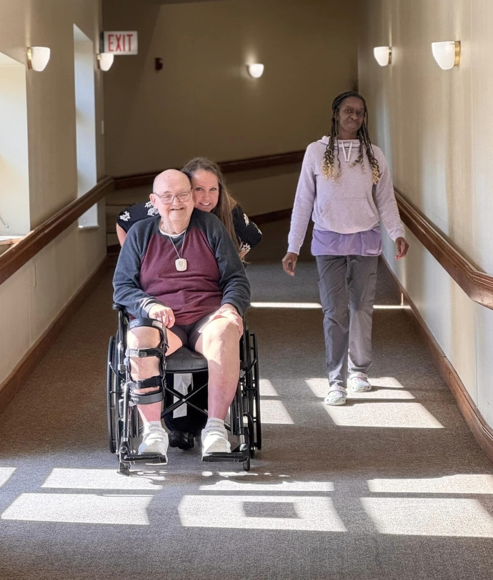 Residents enjoying time in a facility hallway