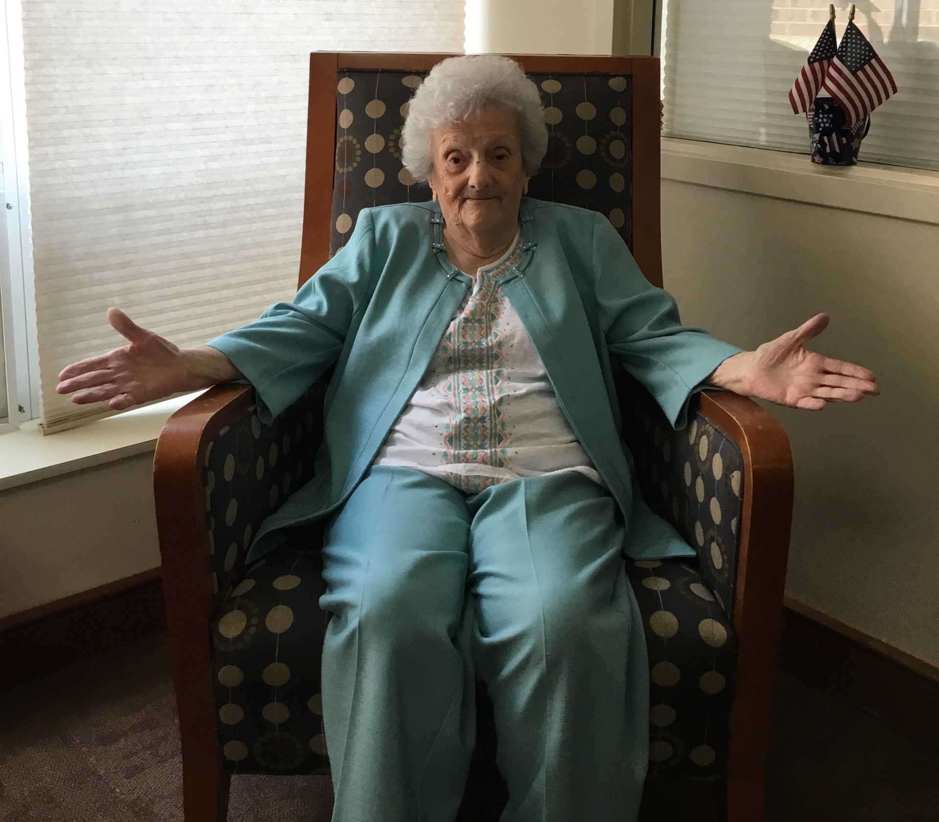 Elderly woman sitting in a chair, smiling