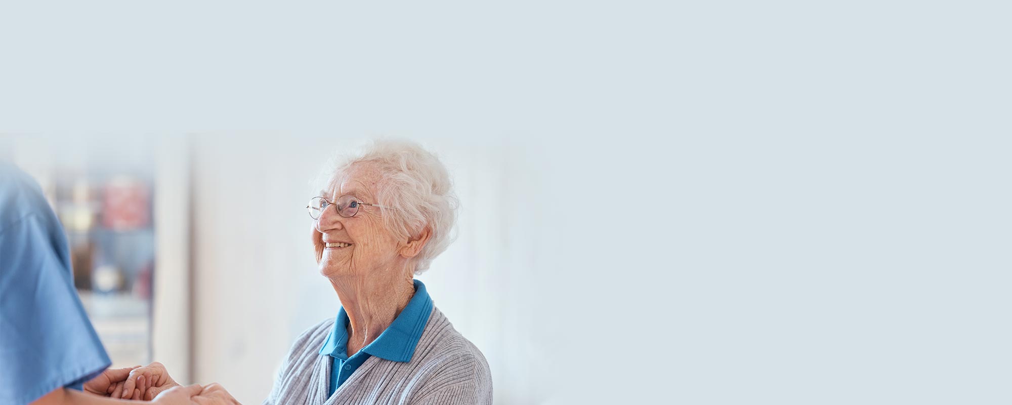 Senior woman smiling while interacting with staff