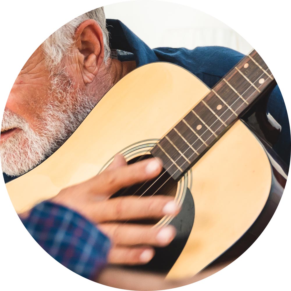 Close-up of a resident playing guitar