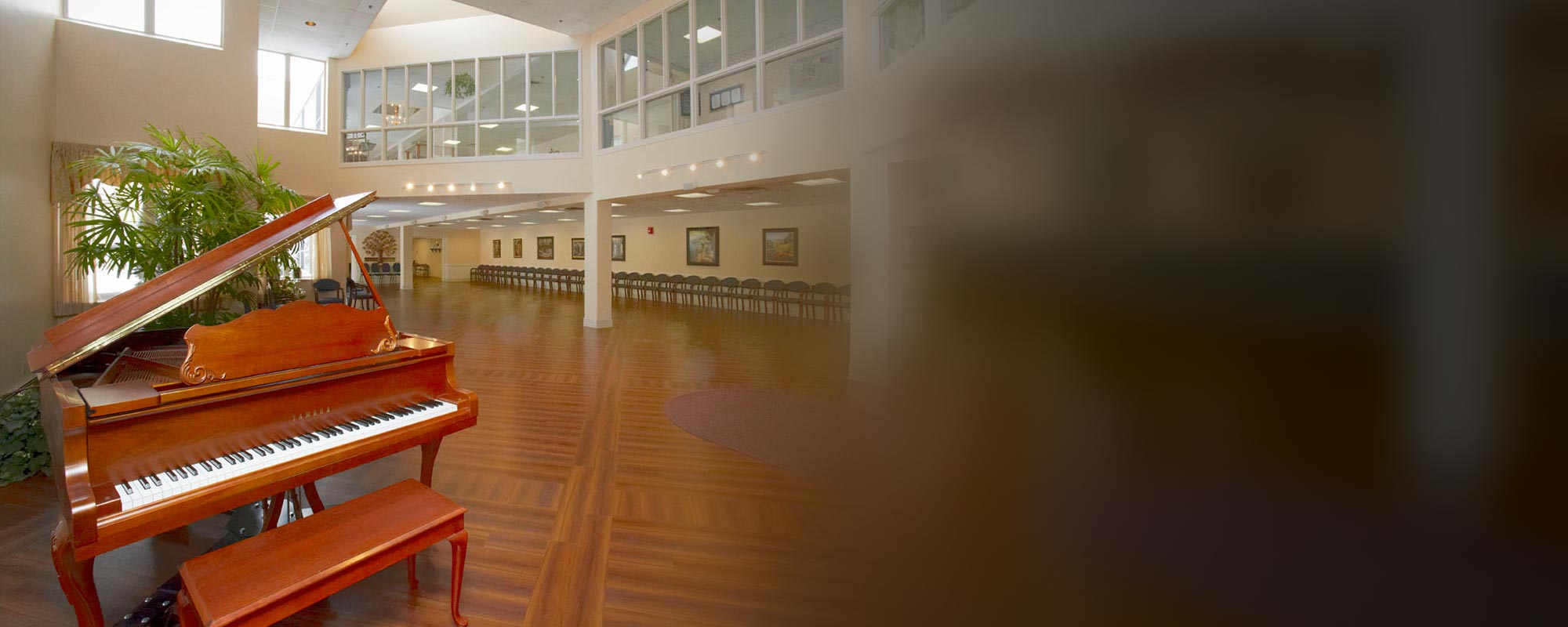 Interior view of a common area with a grand piano.