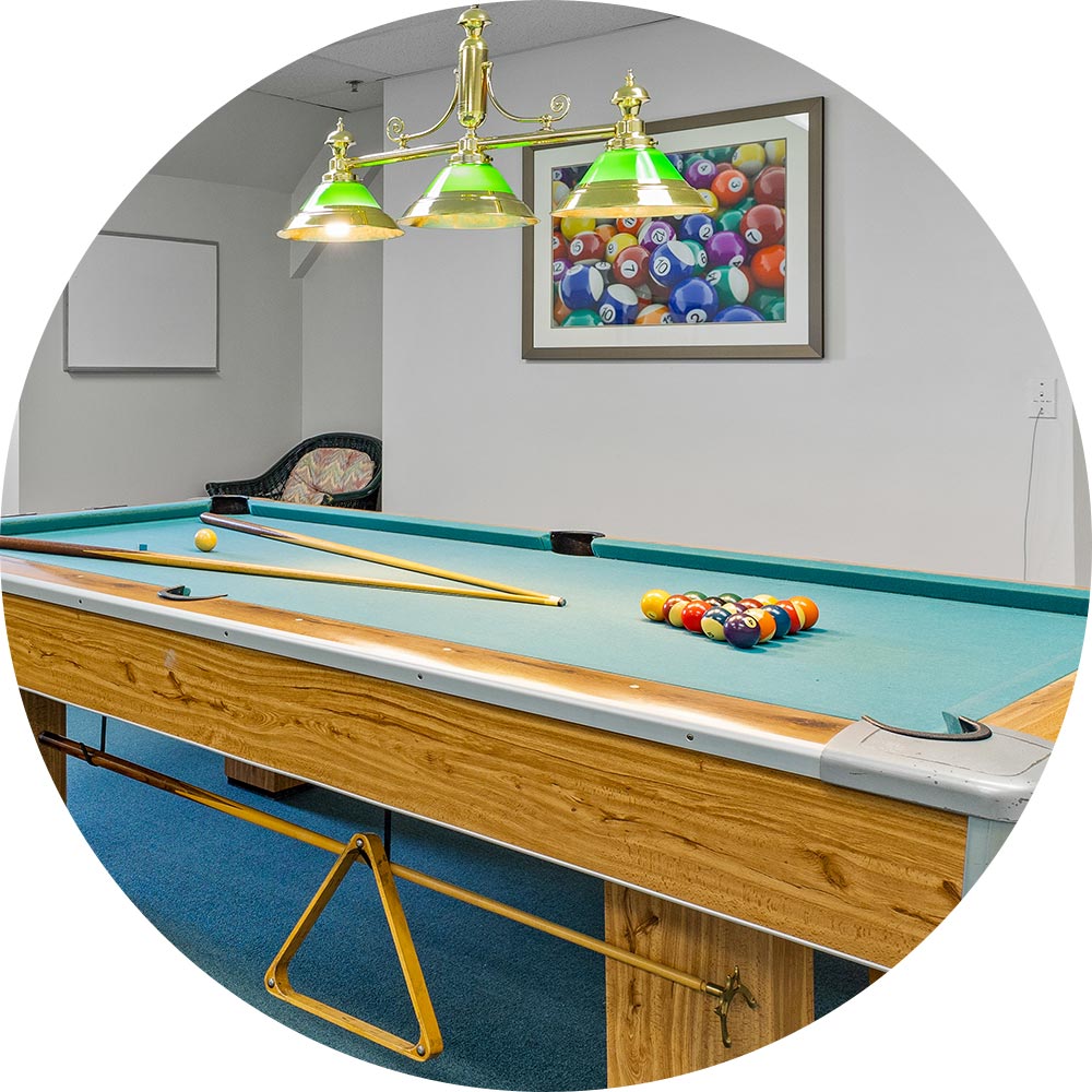 Pool table in a recreational area with colorful balls