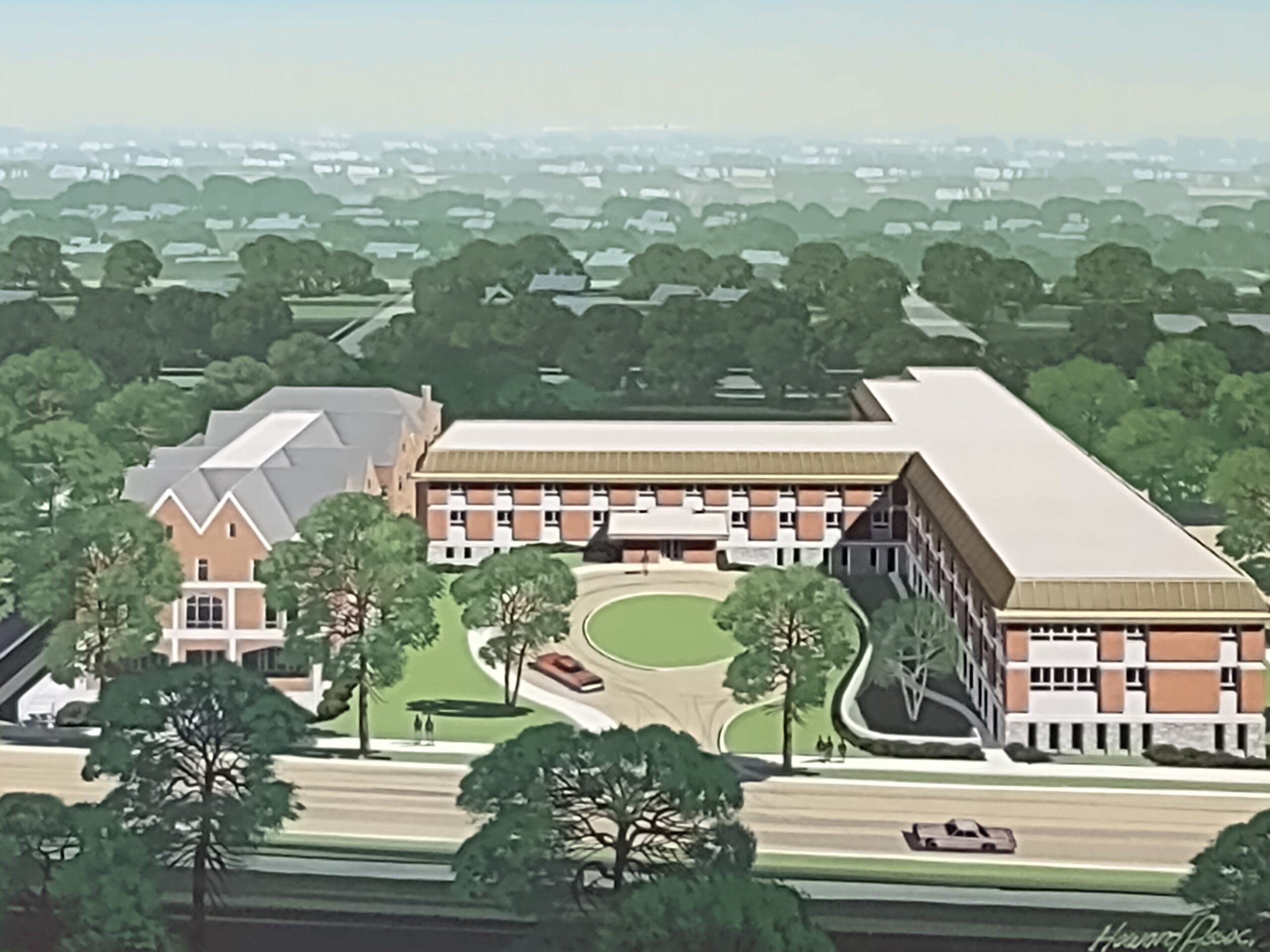 Aerial view of a senior living facility surrounded by greenery.