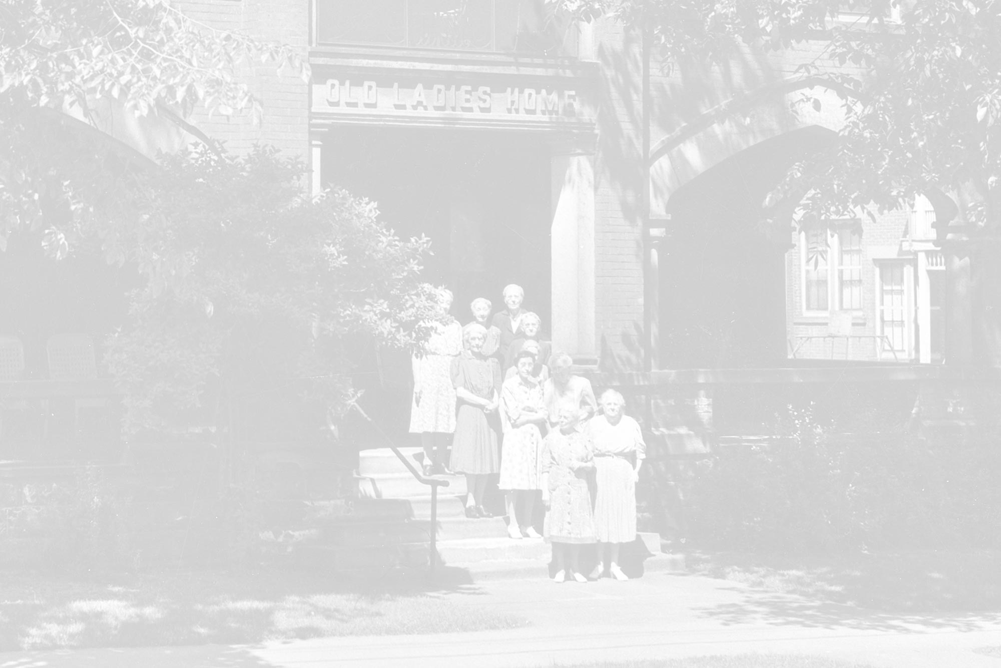 Group of women standing in front of a historic building.