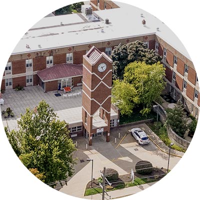Aerial view of the facility's entrance and clock tower.