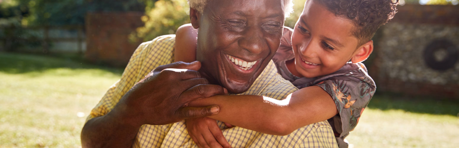 Smiling senior with child enjoying outdoor time