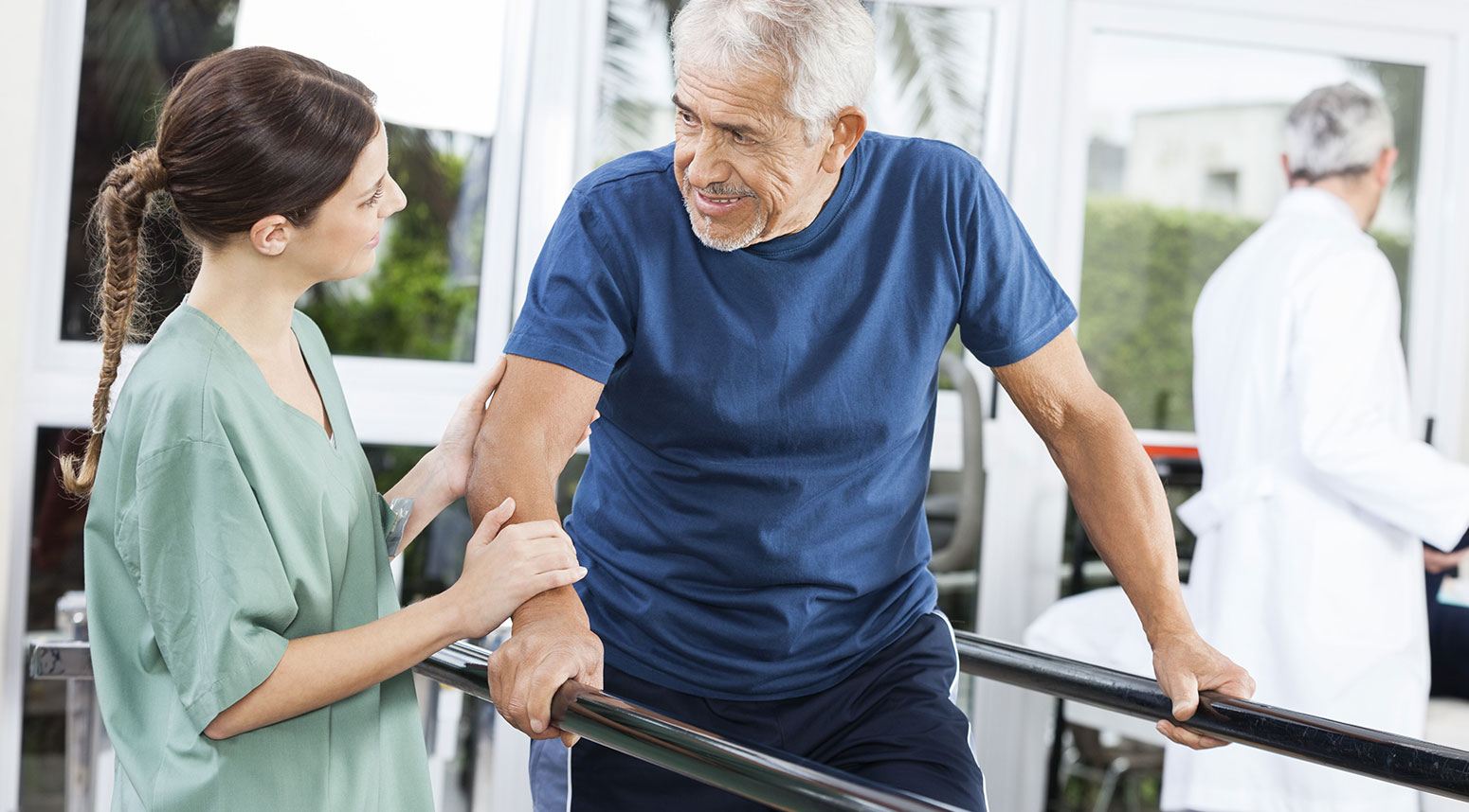 Staff assisting a resident in therapy session.