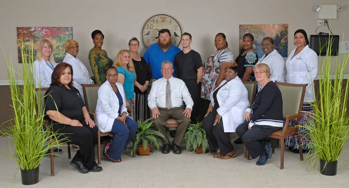 Group photo of staff members in the facility's common area.