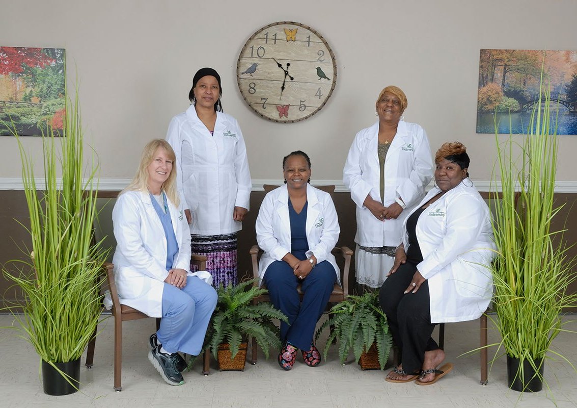 Staff in lab coats posing in a common area