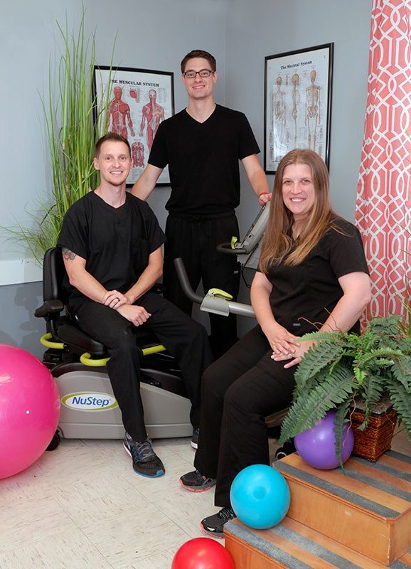 Staff members assisting in a rehabilitation area.